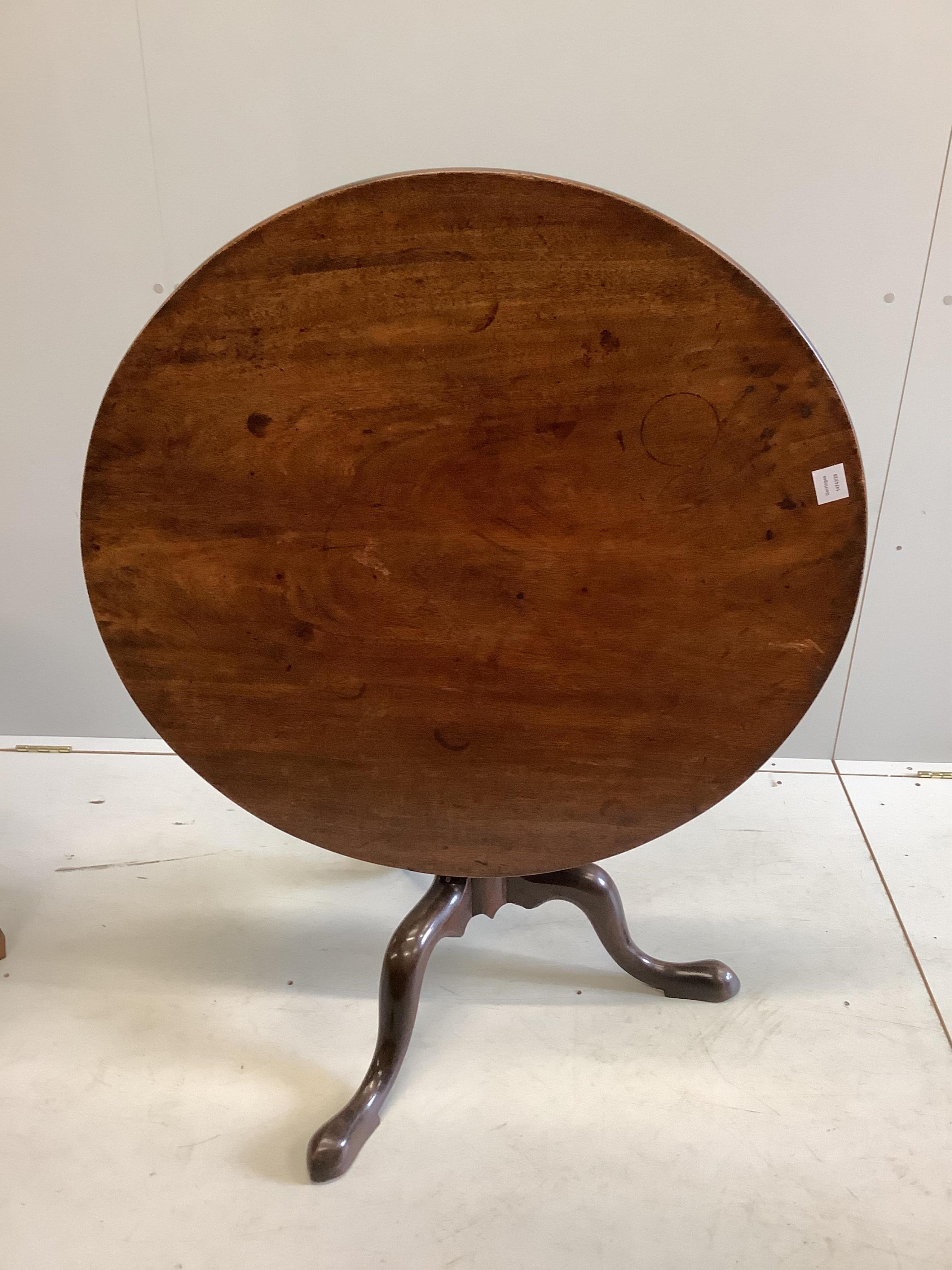 A George III circular mahogany tilt top tripod tea table, diameter 89cm, height 67cm. Condition - fair